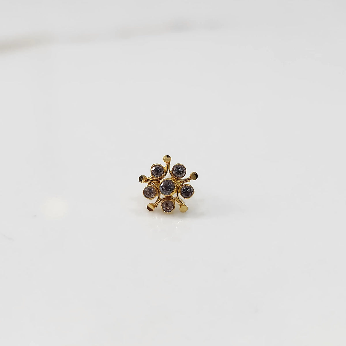 Gold flower nose pin with brown gemstone details