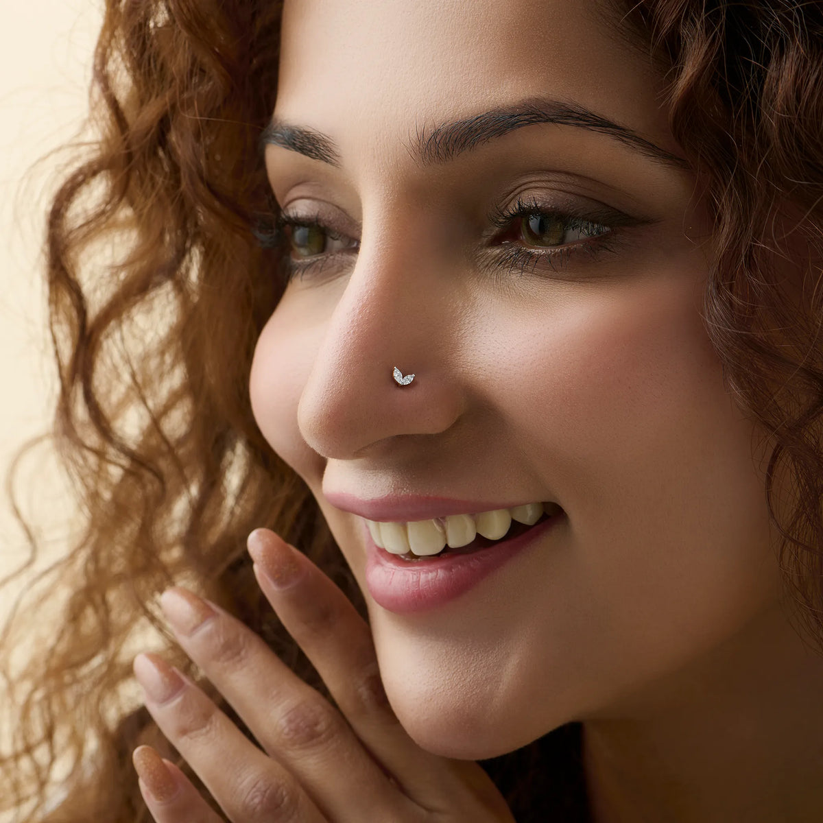 New nose pin design gold worn on the nose in a close-up portrait, showcasing a trendy and graceful everyday jewelry look