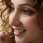 Smiling woman wearing stylish Kerala gold diamond nose pin close-up portrait