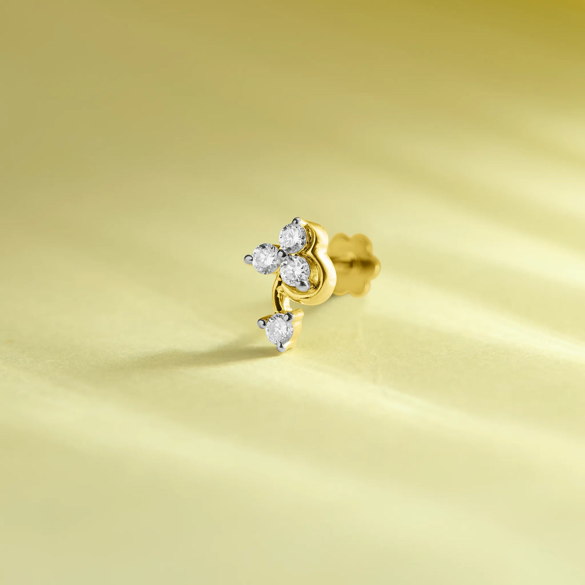 14k gold stud earring featuring a four-diamond cluster with a dangling round diamond below