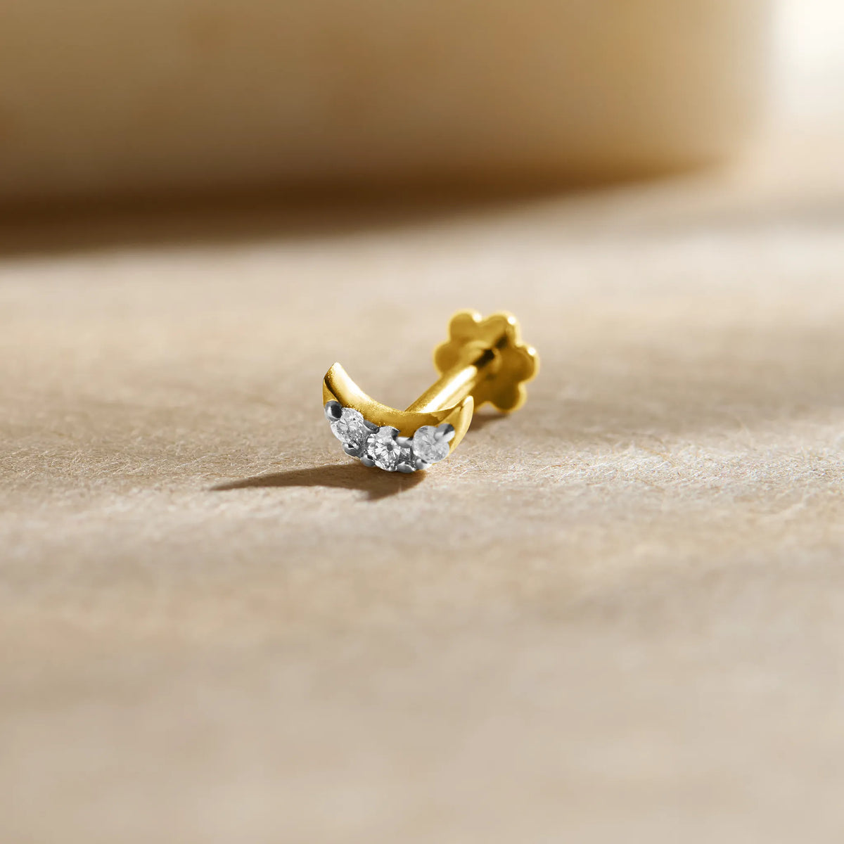 Crescent moon-shaped diamond stud earring in 14k gold