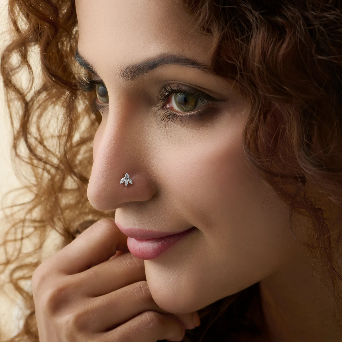 New nose pin design gold worn on the nose in a close-up portrait, showcasing a stylish and graceful everyday jewelry look