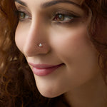 Woman wearing elegant gold nose pin close-up portrait