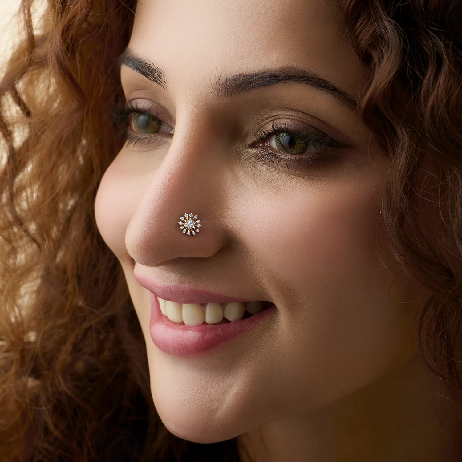 Diamond snowflake design 18K gold nose pin worn by woman