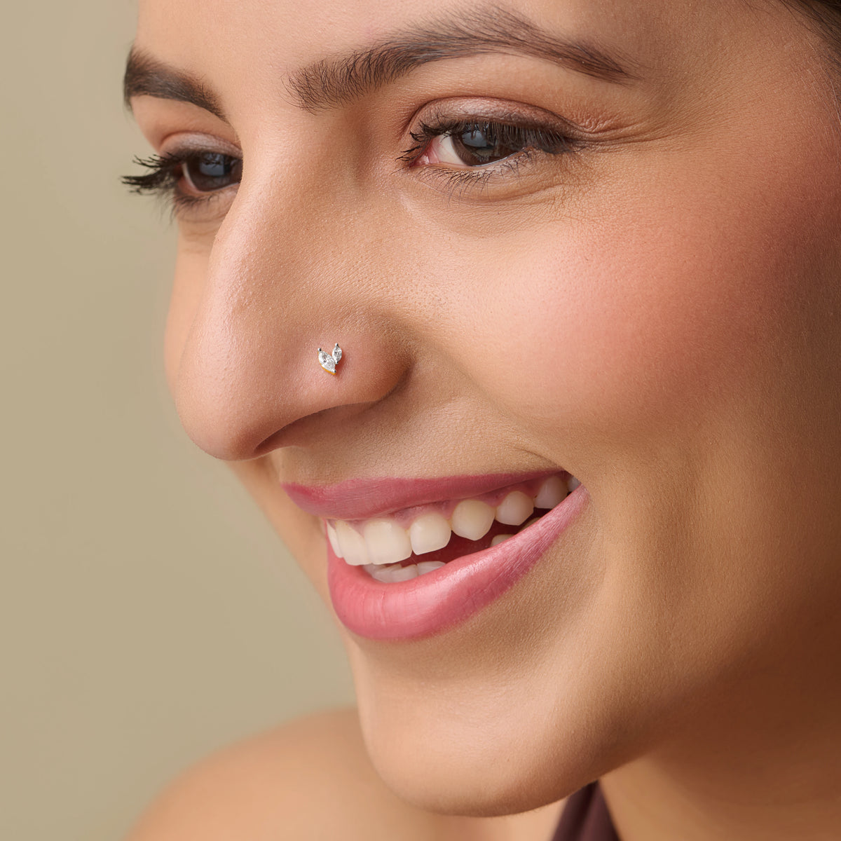 Woman smiling with a small diamond nose pin