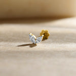 New nose pin design gold with elegant leaf-inspired twin stone pattern set in a polished gold base on a soft neutral background