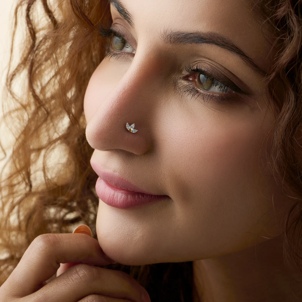 Model showcasing a delicate wing-shaped diamond nose pin