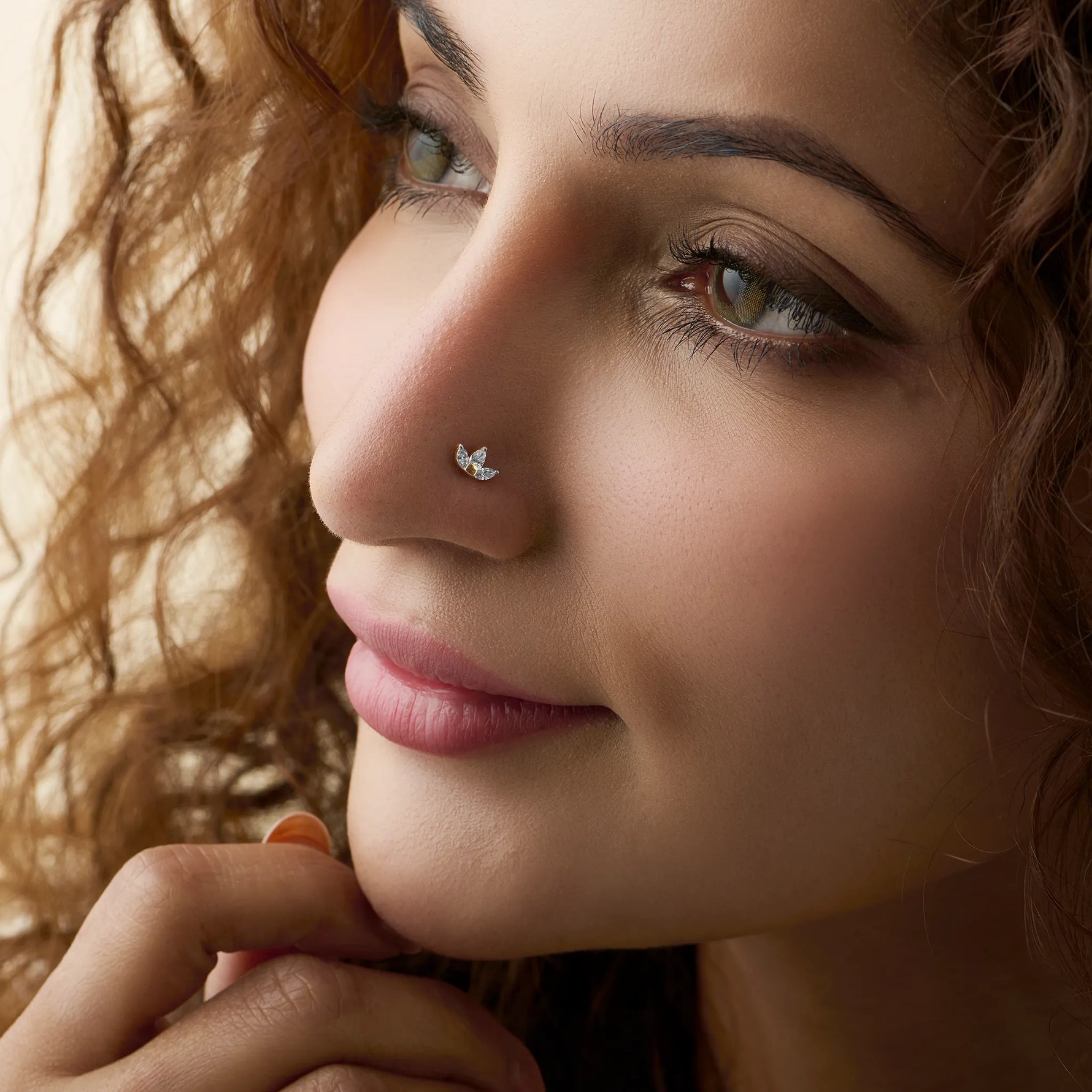 Model showcasing a delicate wing-shaped diamond nose pin