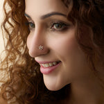 Flower nose pin gold worn on the nose in a close-up portrait, showcasing a charming and elegant everyday jewelry look