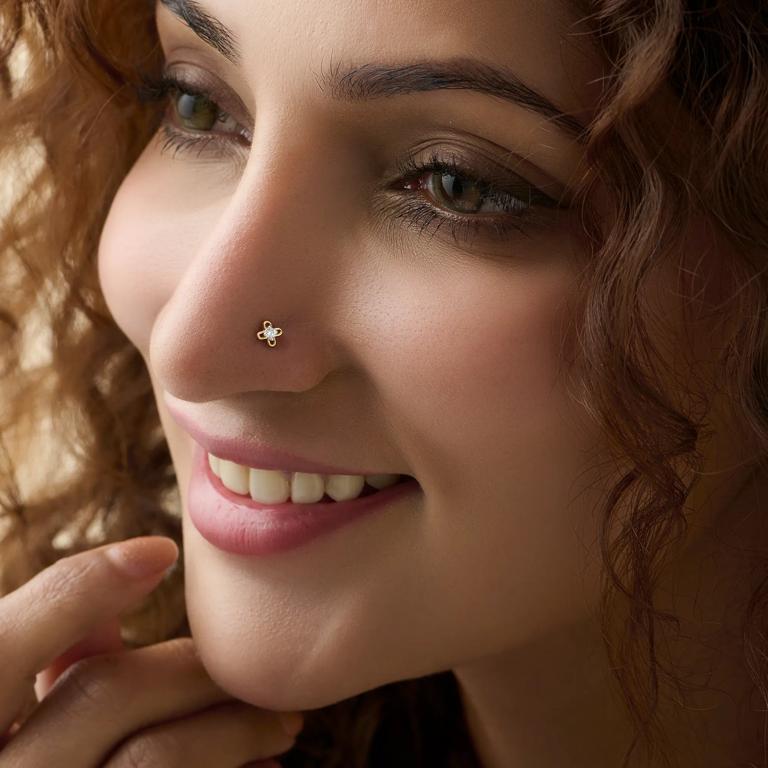 Woman wearing elegant flower gold nose pin close-up portrait