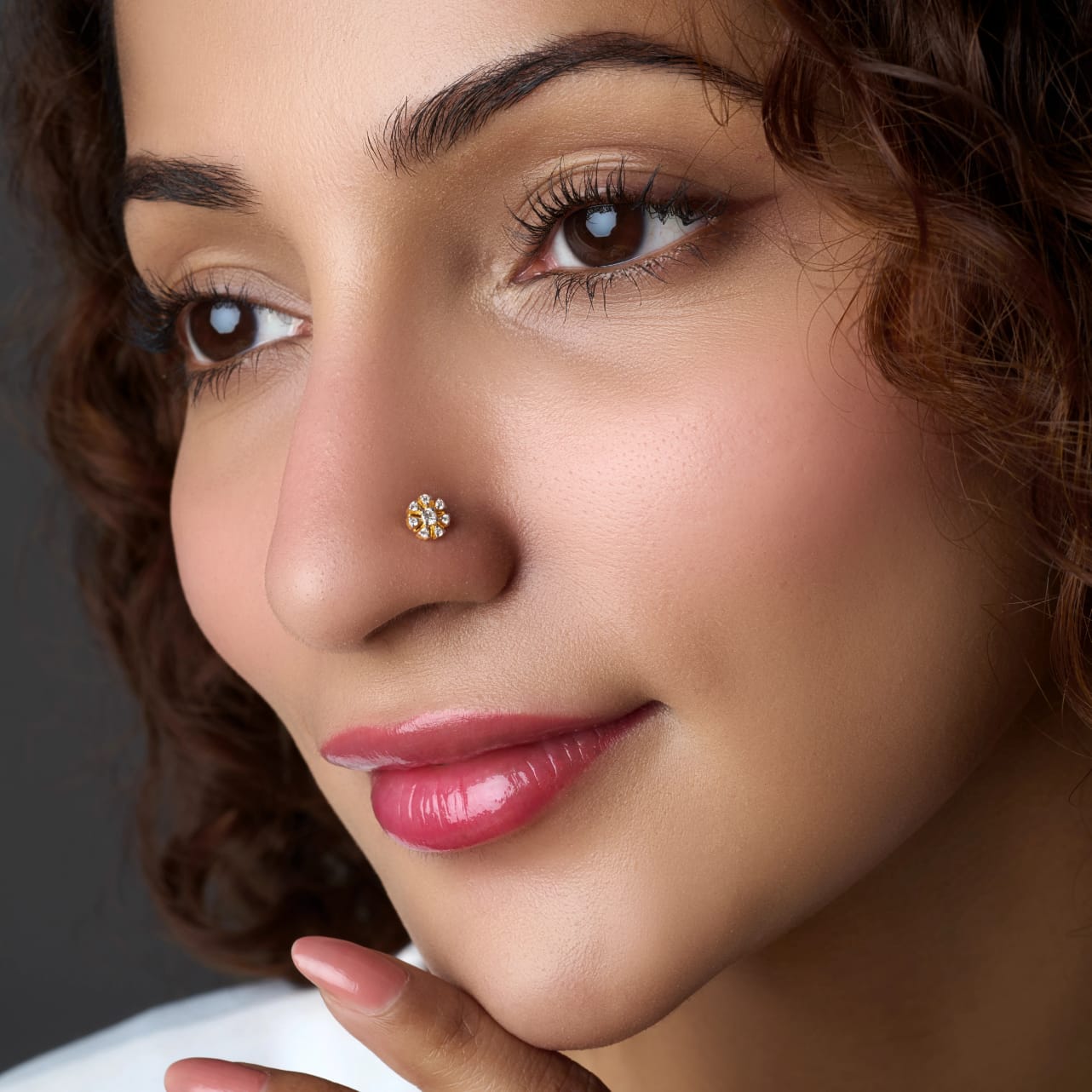Woman wearing a floral gold nose stud
