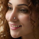 Woman wearing trendy gold floral nose pin close-up portrait