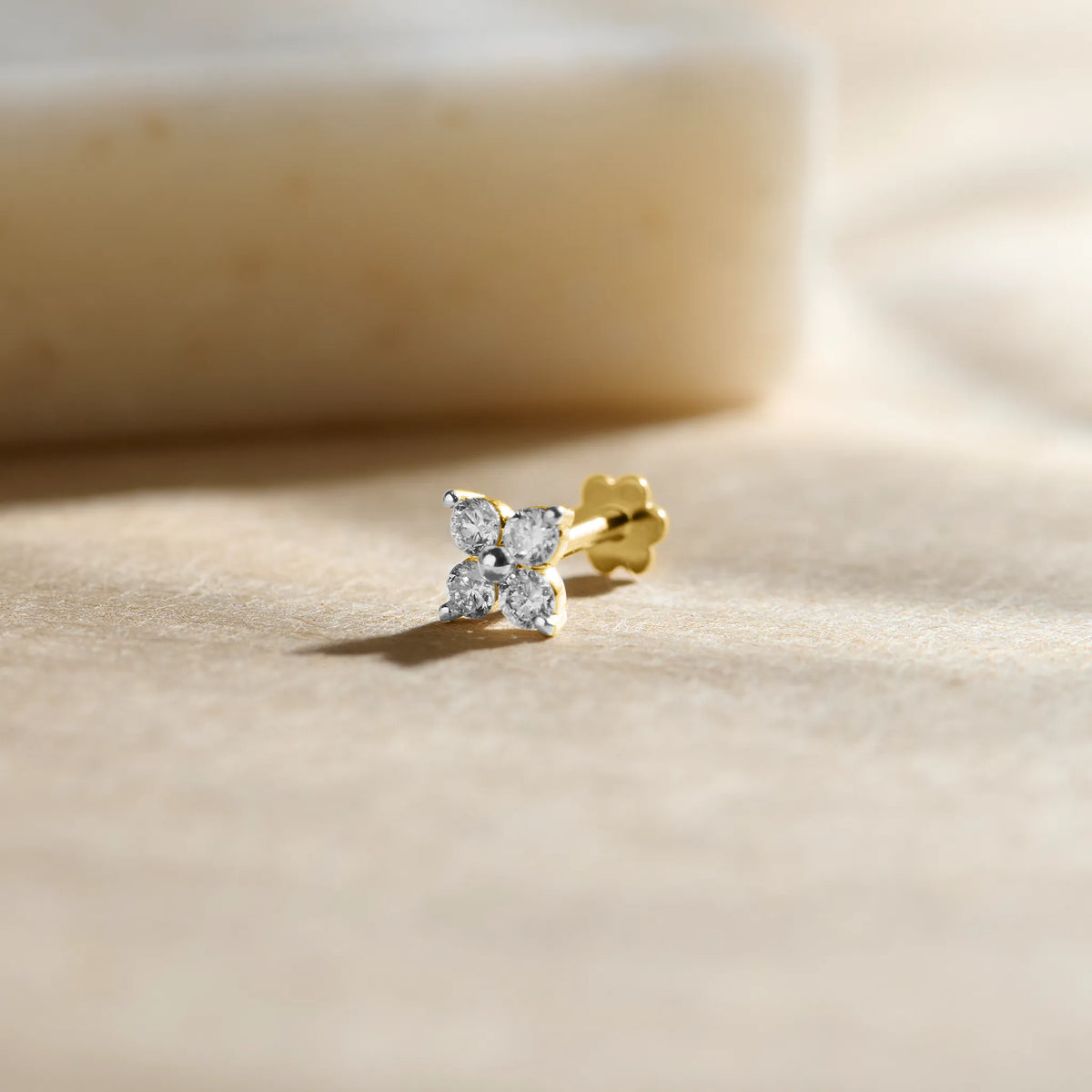 Flower-shaped diamond stud earring with marquise-cut petals in gold