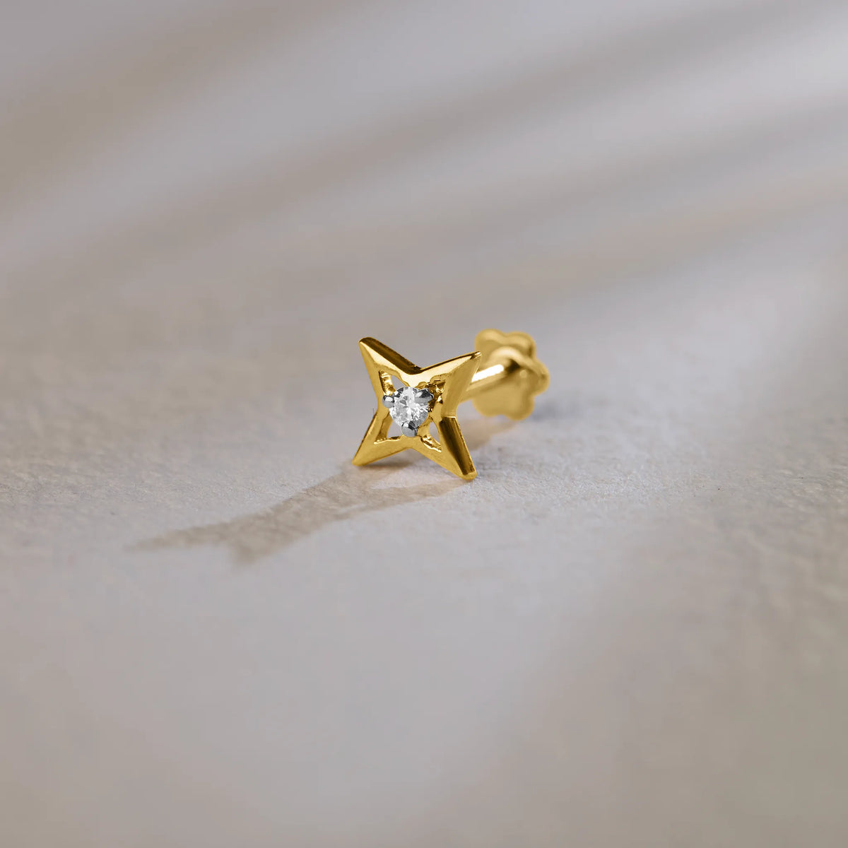 14k gold four-point sparkle star stud earring with princess-cut diamond center