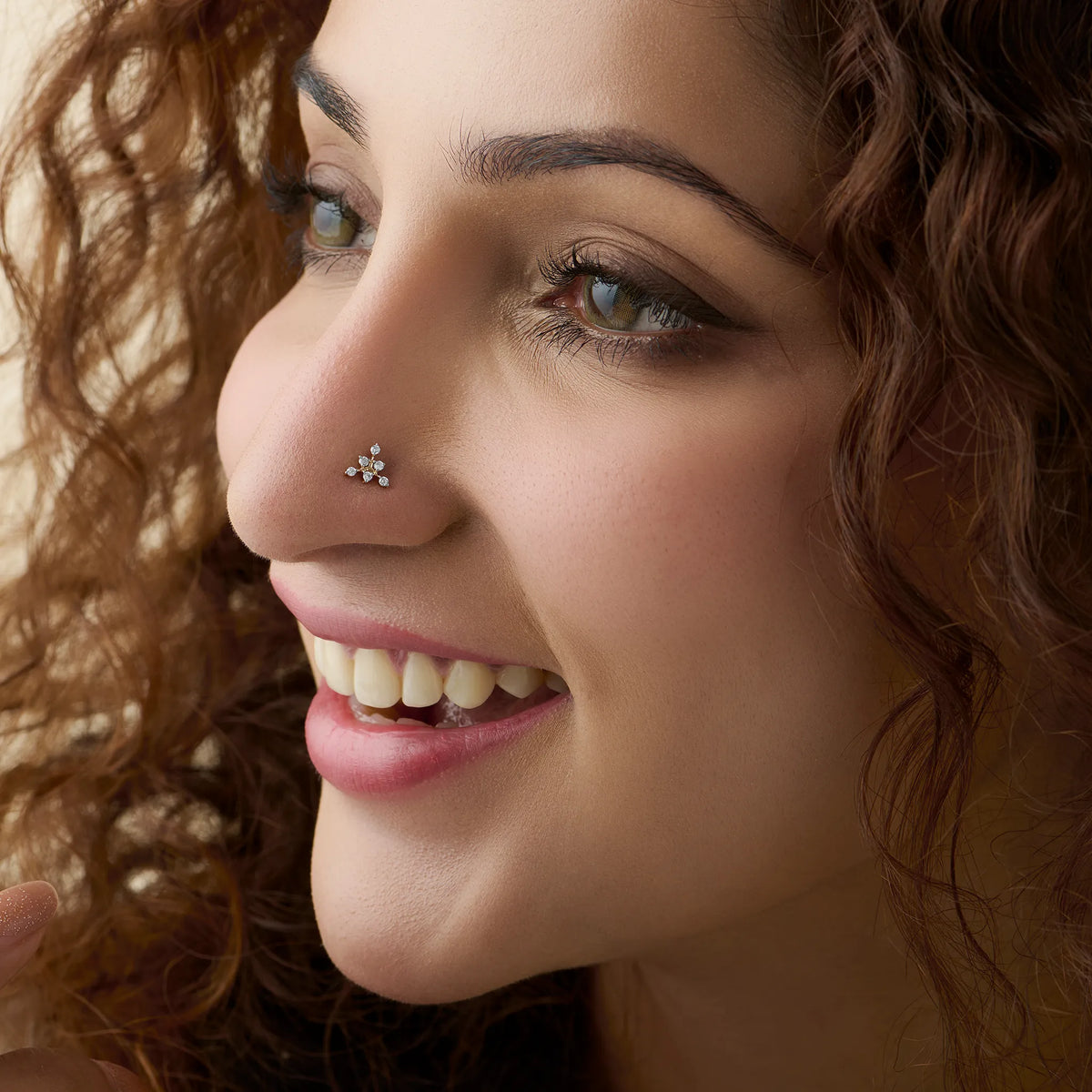 Model showcasing a delicate scattered diamond nose pin