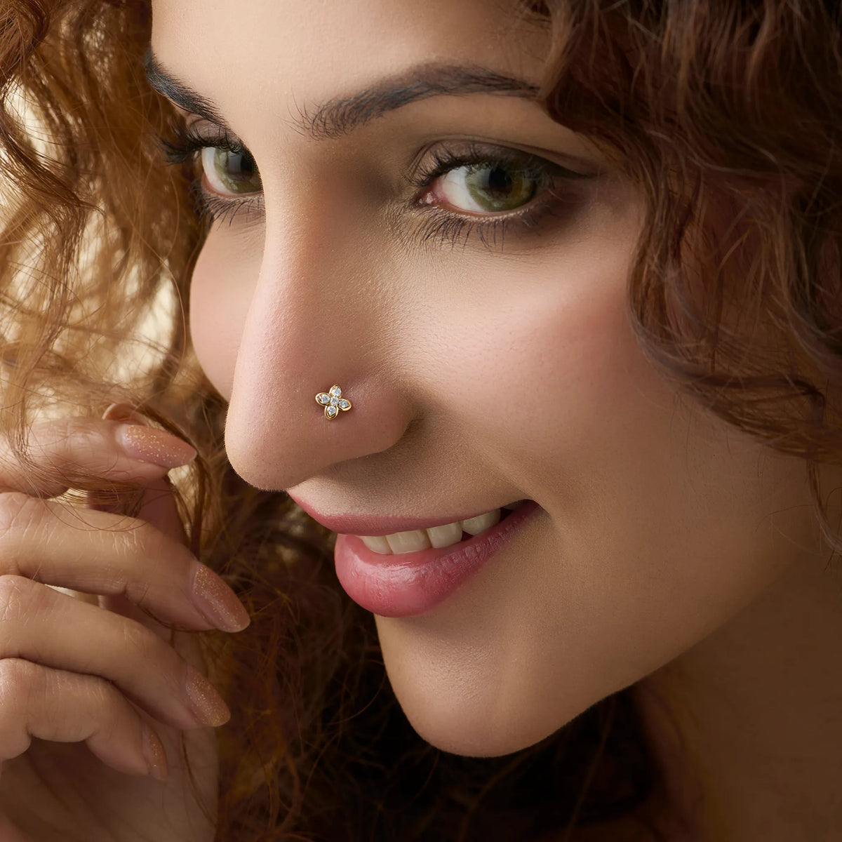 Flower nose pin gold worn on the nose in a close-up portrait, highlighting a stylish and elegant everyday jewelry look