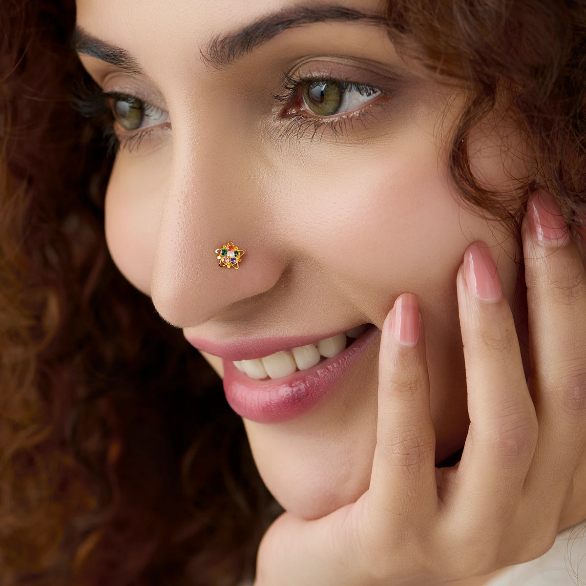 Woman wearing gold 6-petal nose pin with navratna stones