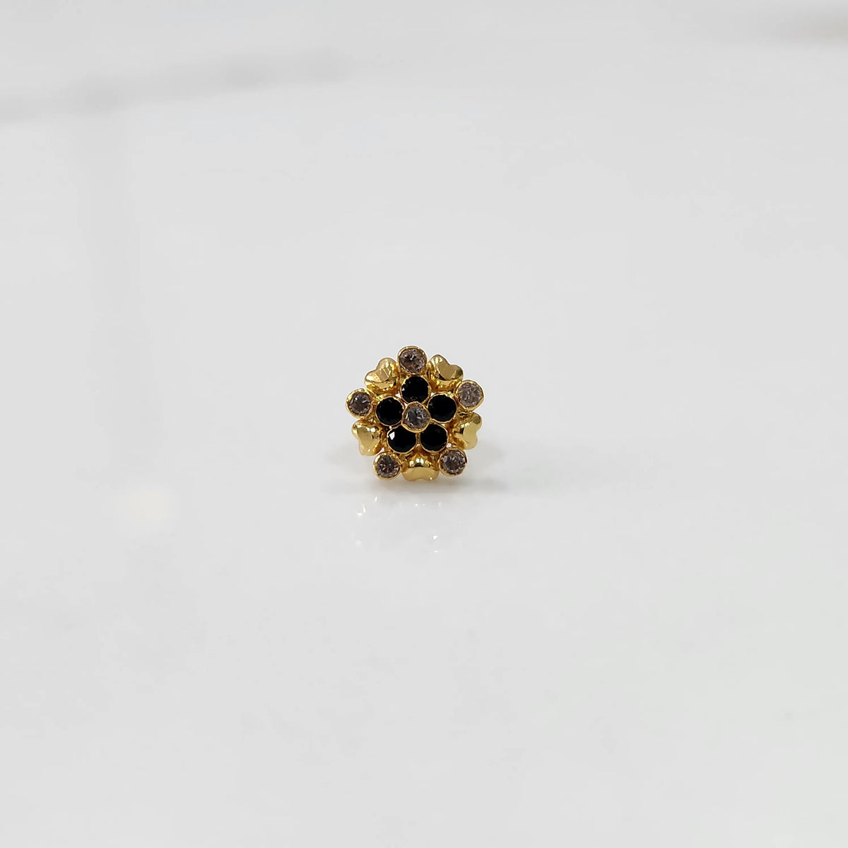 Gold statement ring with black and brown gemstones in textured floral cluster design