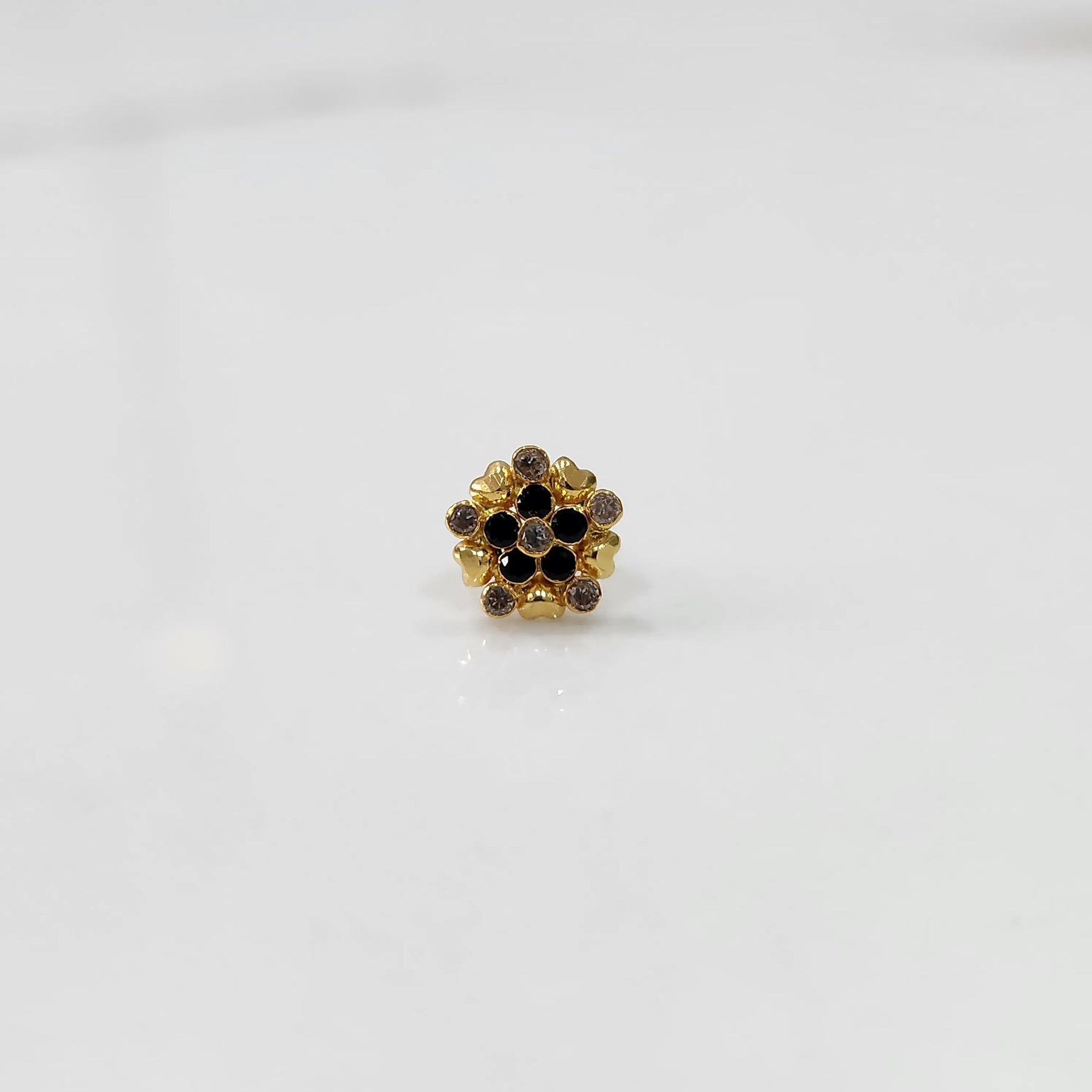 Gold statement ring with black and brown gemstones in textured floral cluster design