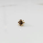 Gold statement ring with black and clear gemstones in floral starburst design