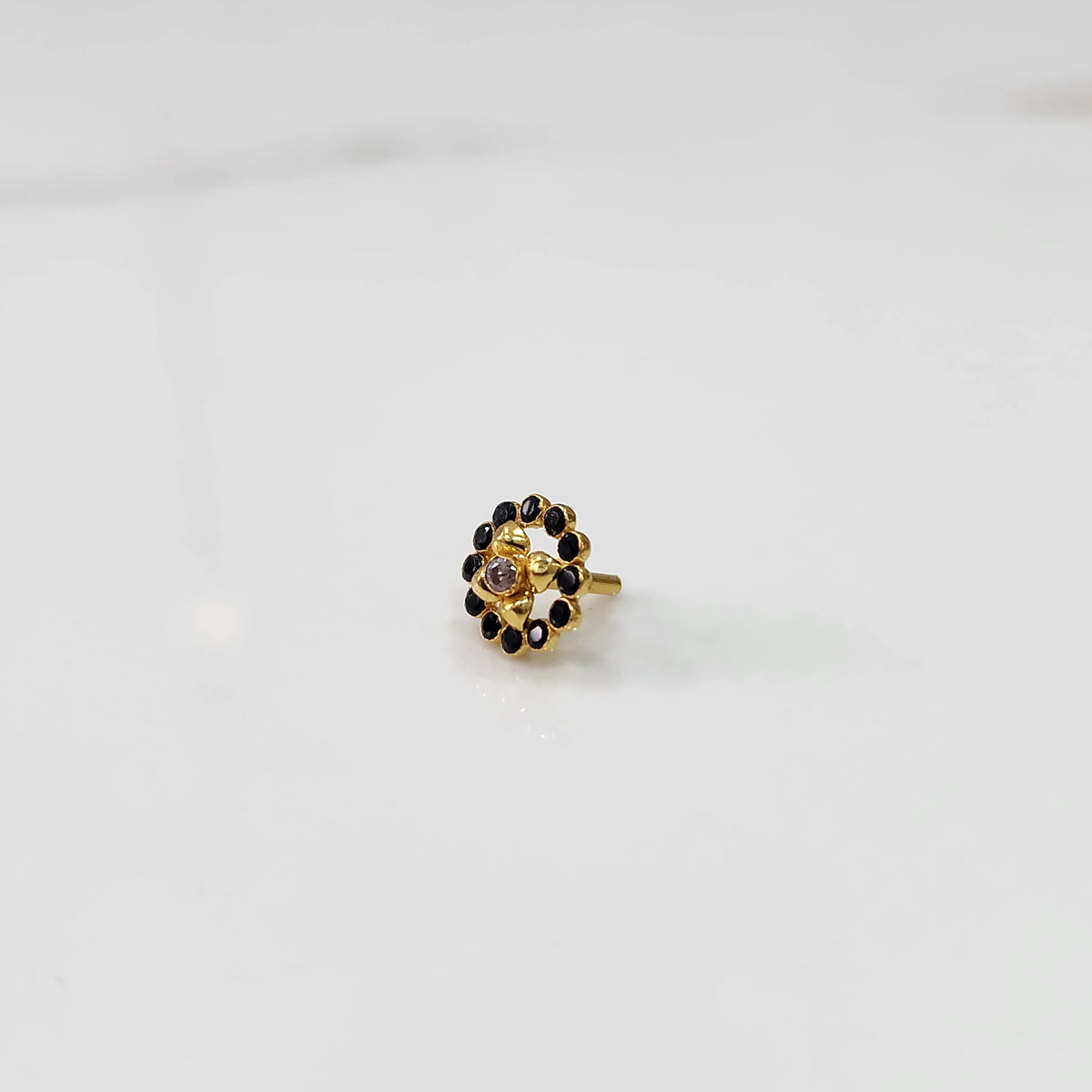 Gold round nose pin with black stones, product shot