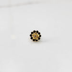Front view of gold floral ring with black gemstone petals