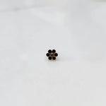 Gold flower stud earring with black stones and white center stone