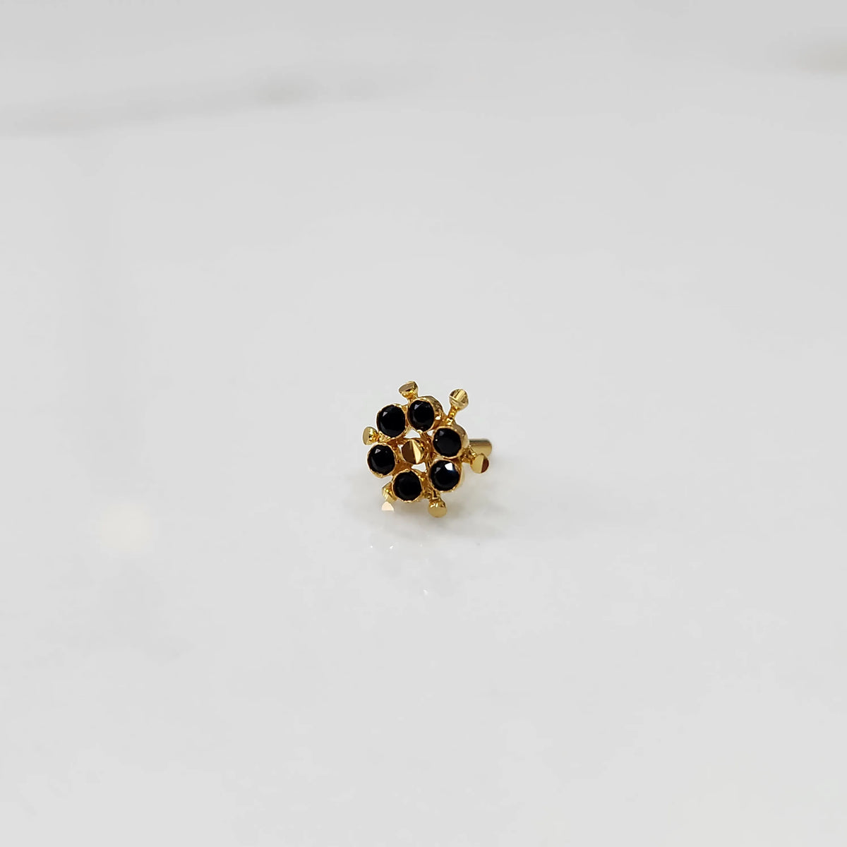 Gold statement ring with black gemstones in scattered dotted cluster design