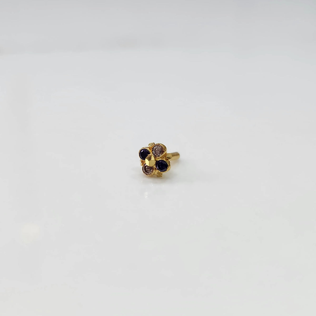Gold floral ring with blue and brown gemstones