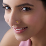 Woman wearing a bow-shaped gold nose pin