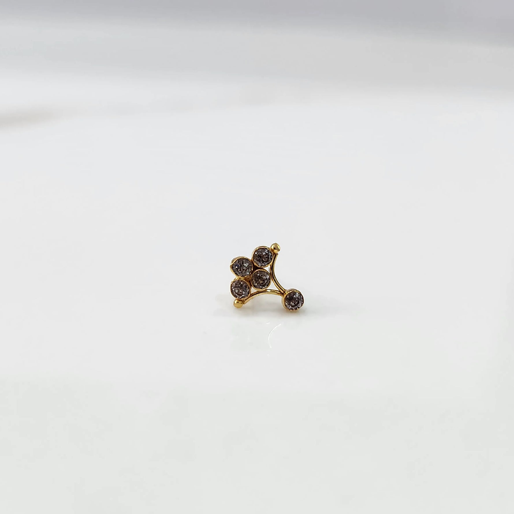 Side view of gold ring featuring brown gemstone cluster on branch design