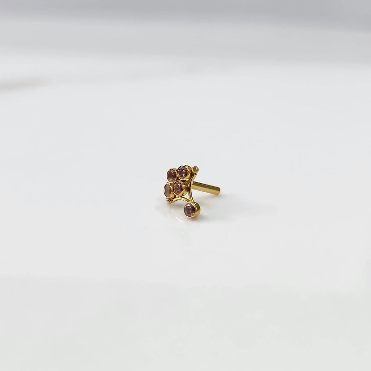 Side view of gold ring featuring pink gemstone cluster on branch design