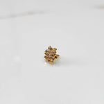 Gold statement ring with brown and clear gemstones in dense cluster design