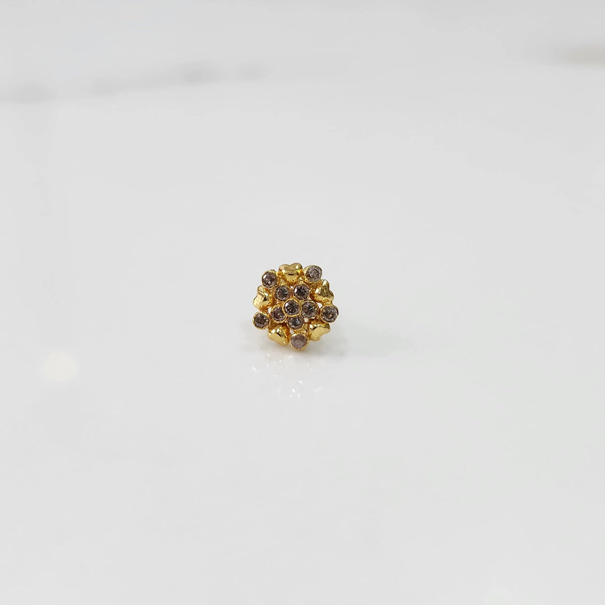 Gold statement ring with brown gemstones in textured floral cluster design