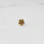 Gold statement ring with brown gemstones in textured floral cluster design