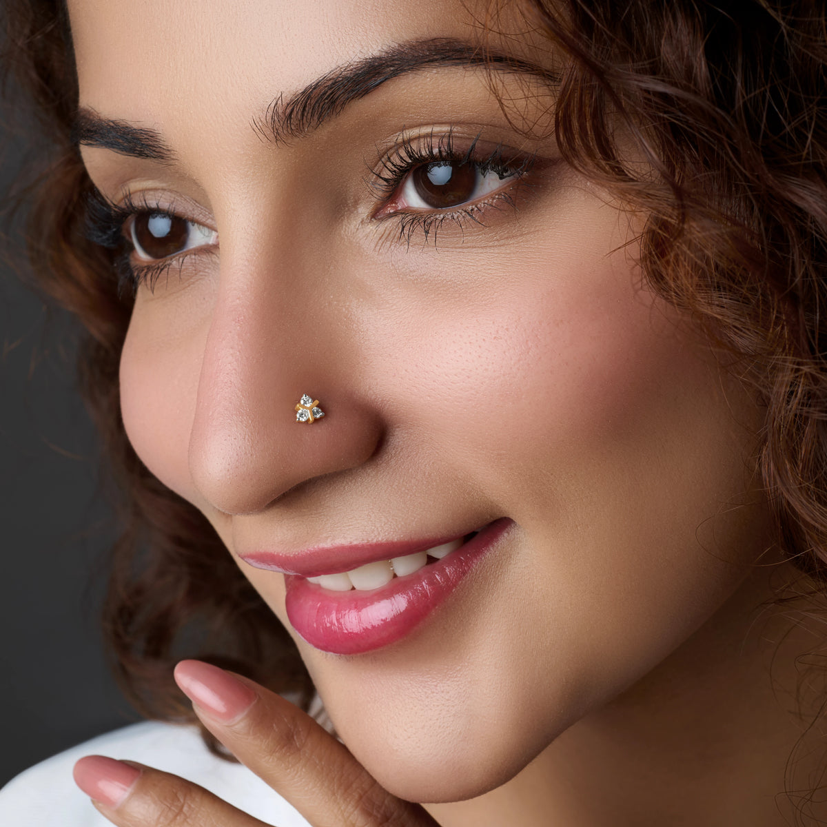 Woman wearing a butterfly-shaped gold nose pin