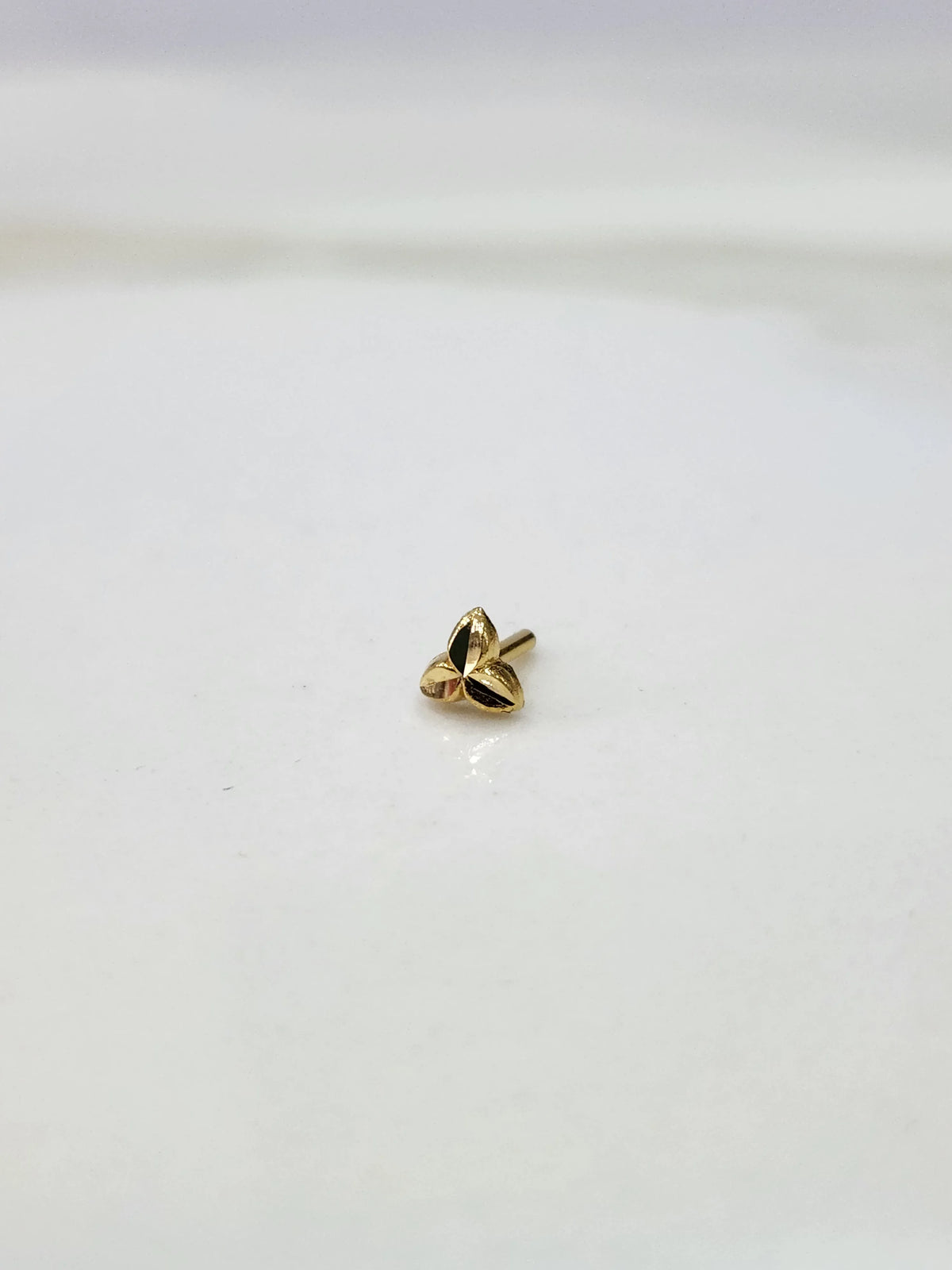 Simple gold nose pin design with measurement scale showing dimensions