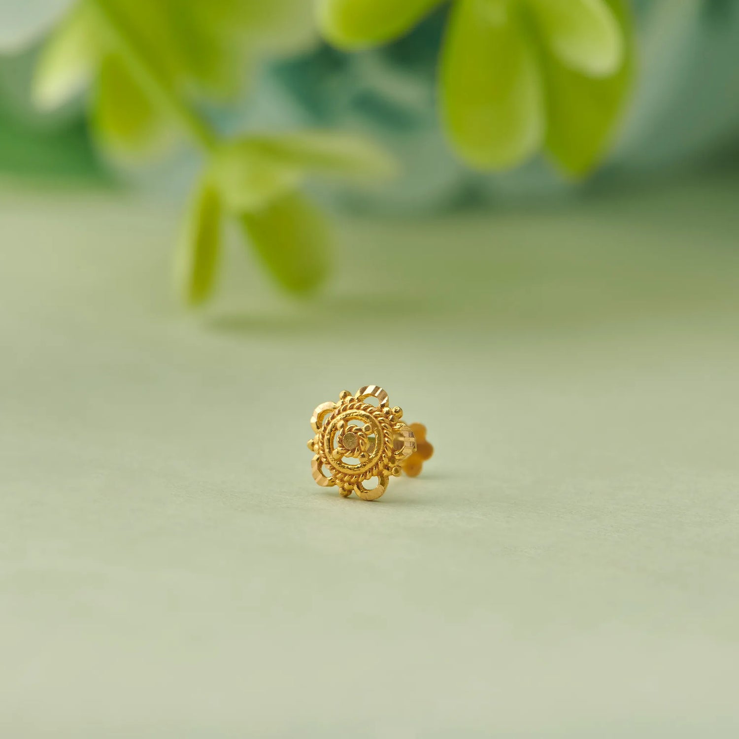 Gold floral stud earring with crown-edge detailing