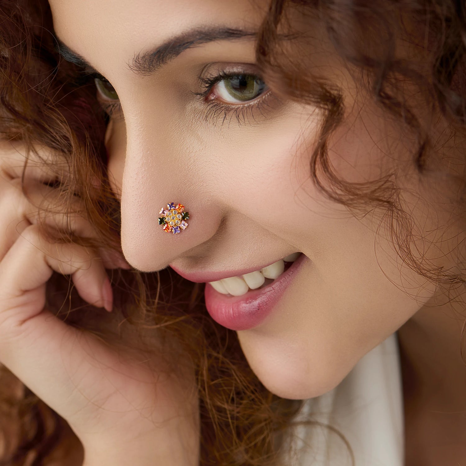 Woman wearing dense multicolor floral gold nose pin