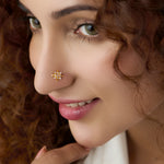 Woman wearing elegant stone gold nose pin with minimal look