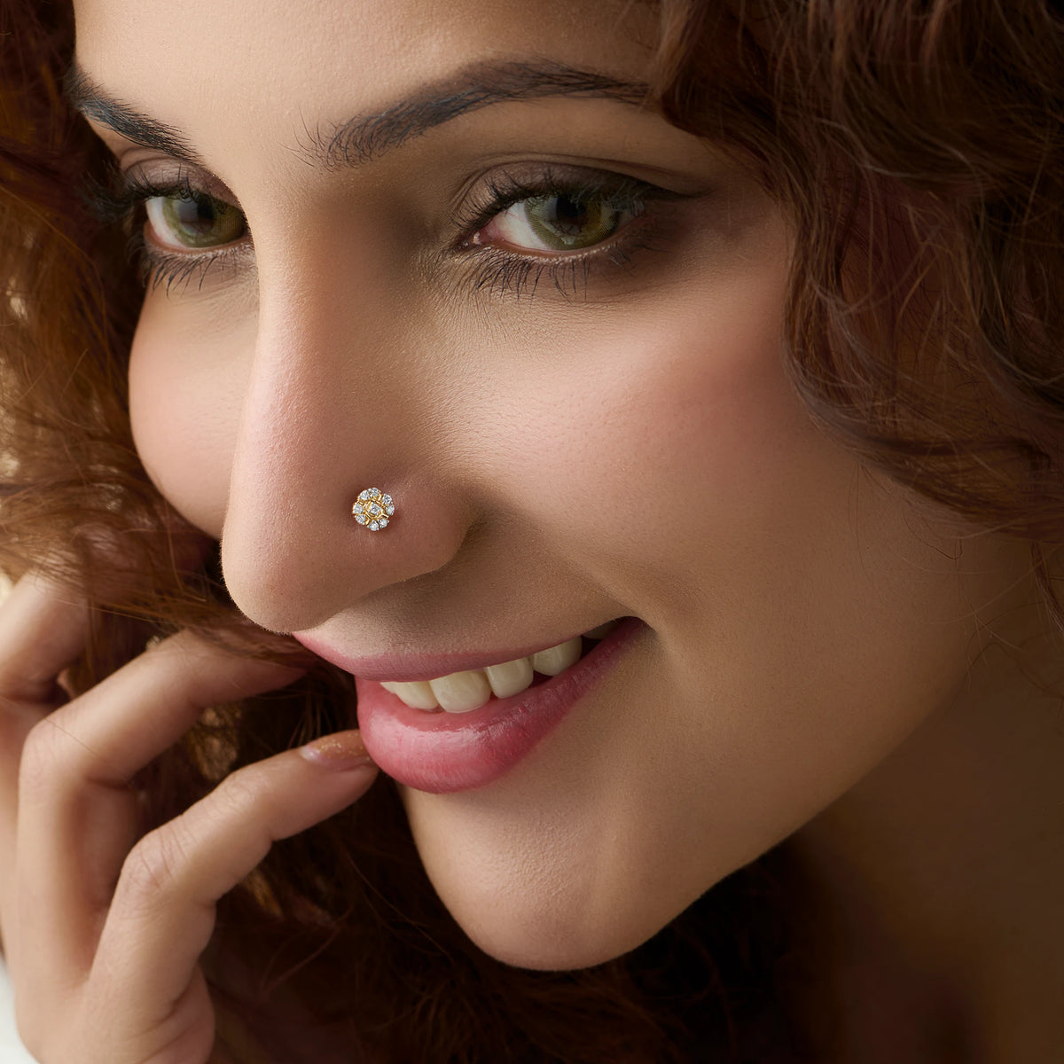 Woman wearing a floral diamond gold nose pin