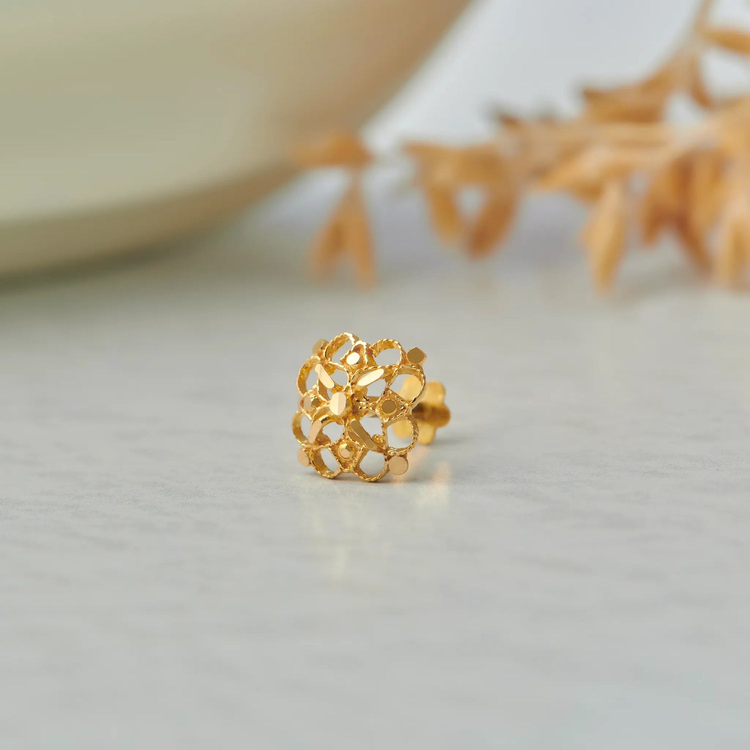 Gold stud earring with domed lattice cutout design