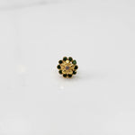 Front view of gold floral ring with green gemstone petals