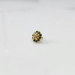 Gold floral ring with emerald-green outer stones and gold inner stones