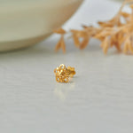 Gold flower-shaped stud earring with filigree cutout design