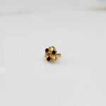 Gold filigree ring with black and clear gemstones