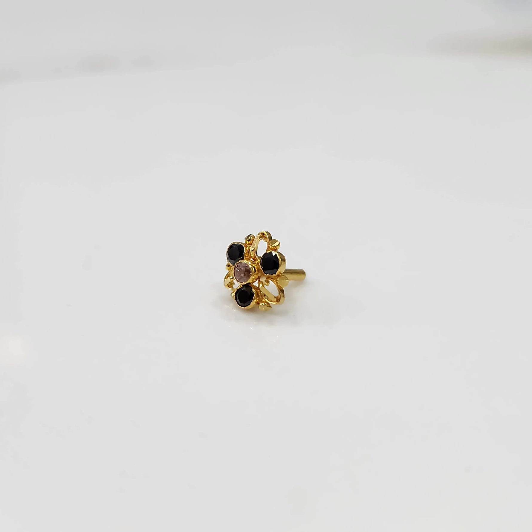 Gold filigree ring with black and clear gemstones