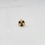 Top view of gold filigree ring with green oval gemstones