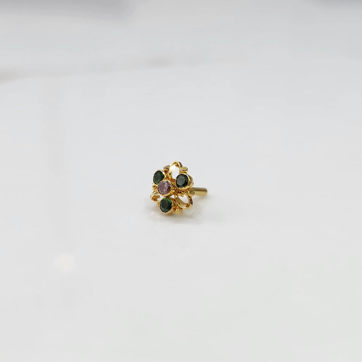 Gold filigree ring with green and lavender gemstones