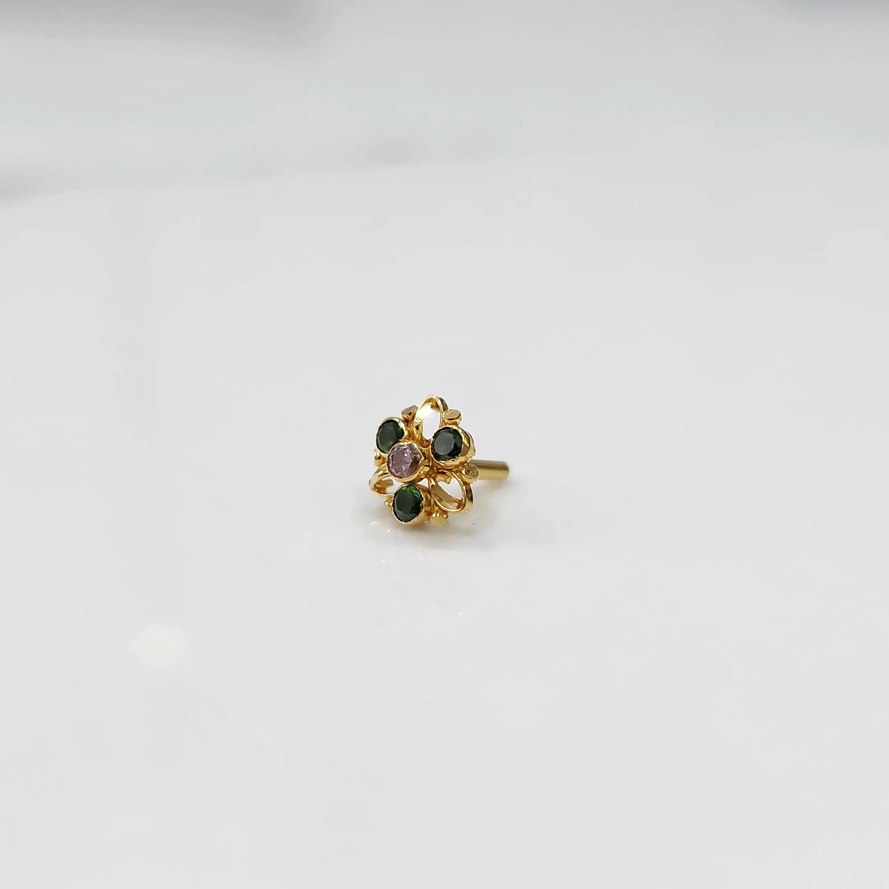 Gold filigree ring with green and lavender gemstones